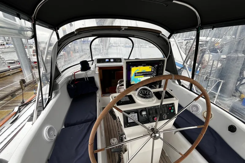 Slide: The Image of Cockpit of 1999 Oyster 53 Deck Saloon yacht with navigation equipment and steering wheel. - 77