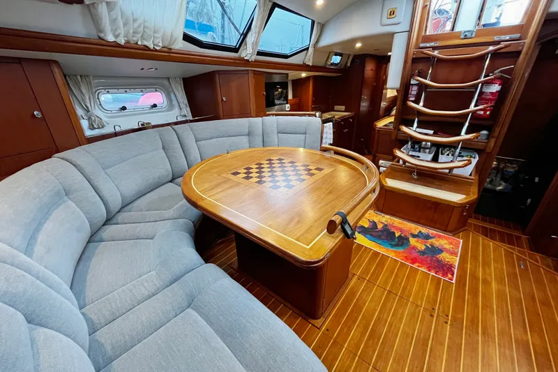 Slide: The Image of Luxurious interior of 1999 Oyster 53 Deck Saloon yacht with elegant seating and chessboard table. - 15