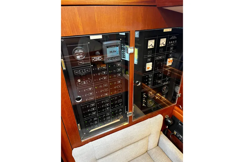 Slide: The Image of Electrical control panel on a 1999 Oyster 53 Deck Saloon yacht, featuring gauges and switches. - 49