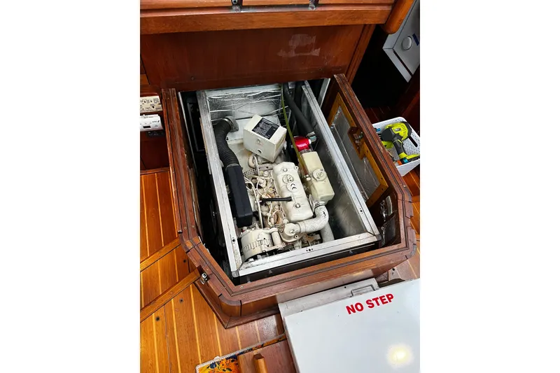 Slide: The Image of Engine compartment of a 1999 Oyster 53 Deck Saloon yacht, featuring a visible engine. - 57