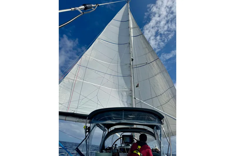 Slide: The Image of Sailing on a 1999 Oyster 53 Deck Saloon under clear blue skies. - 82