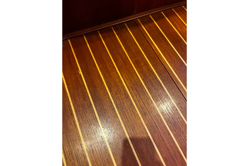Slide: The Image of Teak wood flooring on a 1999 Oyster 53 Deck Saloon yacht. - 33