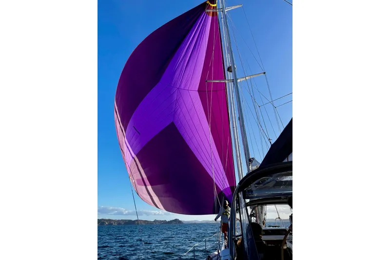Slide: The Image of Sailing yacht Oyster 53 Deck Saloon 1999 with vibrant purple spinnaker on open water. - 83