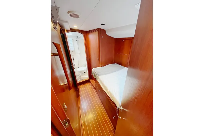 Slide: The Image of Cozy cabin interior of 1999 Oyster 53 Deck Saloon yacht with wooden finish and ensuite bathroom. - 3