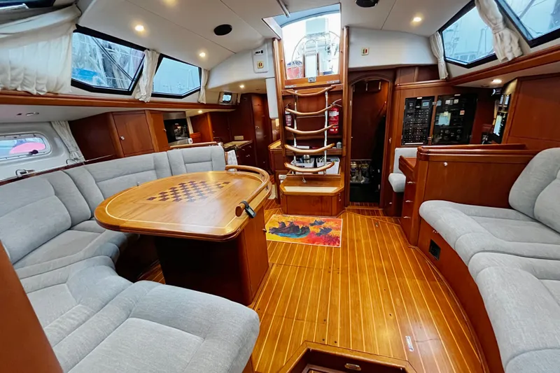 Slide: The Image of Luxurious interior of a 1999 Oyster 53 Deck Saloon yacht with elegant wood finishes. - 11