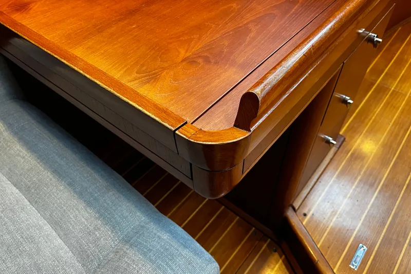 Slide: The Image of Wooden interior of 1999 Oyster 53 Deck Saloon, featuring polished cabinetry and flooring. - 34