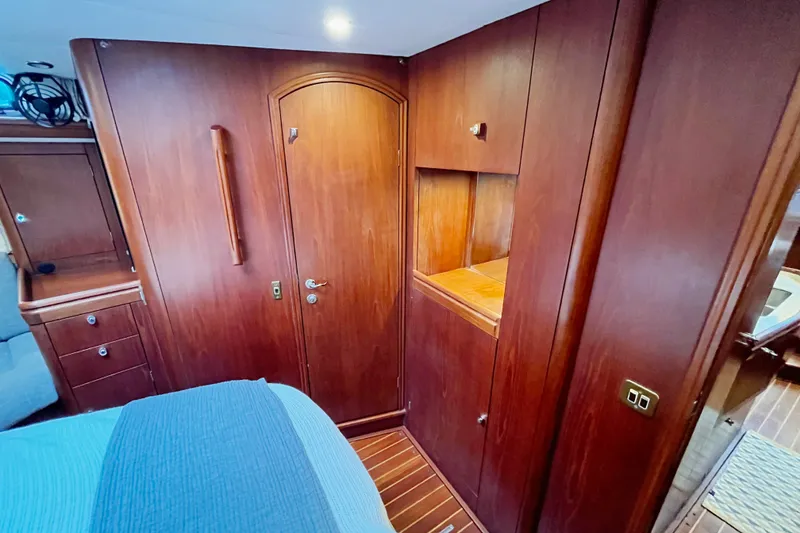 Slide: The Image of Interior of 1999 Oyster 53 Deck Saloon with wooden cabinetry and cozy design. - 29