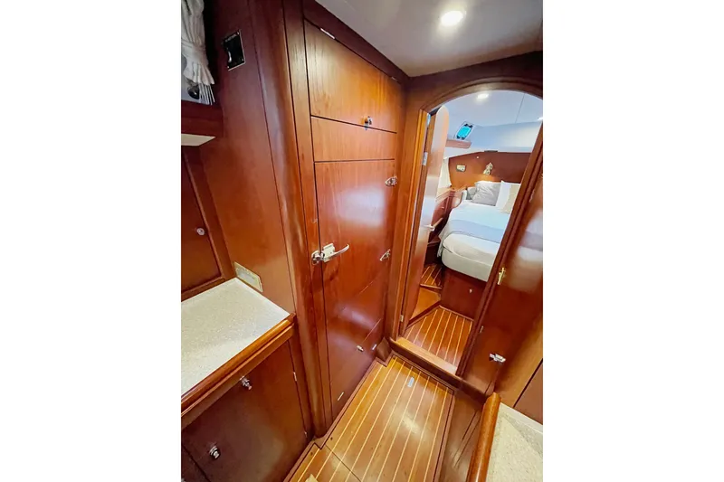 Slide: The Image of Interior of 1999 Oyster 53 Deck Saloon yacht with wooden cabinetry and cozy bedroom. - 26