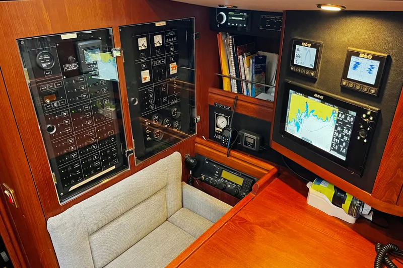 Slide: The Image of Navigation station of a 1999 Oyster 53 Deck Saloon yacht with control panels and displays. - 20