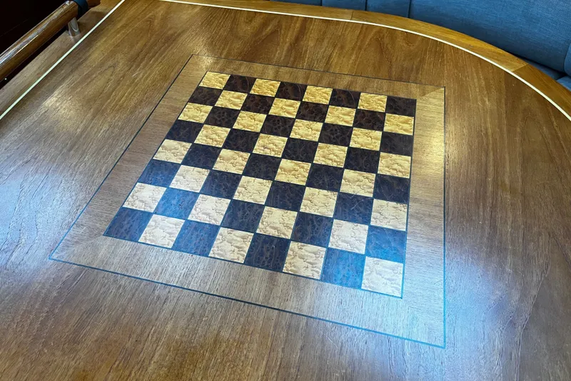 Slide: The Image of Wooden chessboard inlaid on a table aboard a 1999 Oyster 53 Deck Saloon yacht. - 40