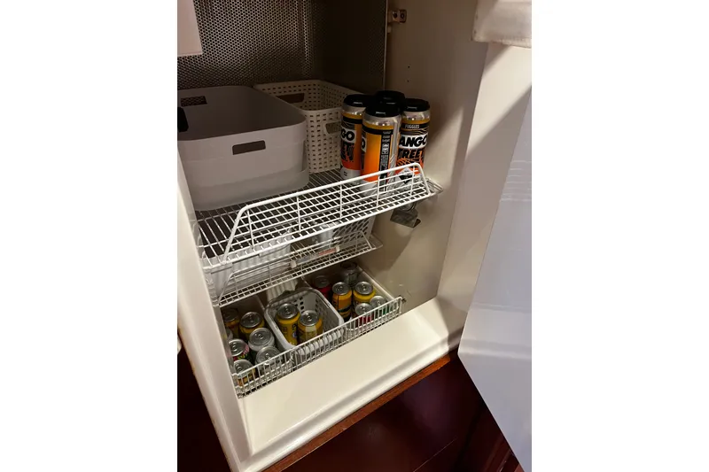 Slide: The Image of Storage area with canned drinks and baskets on Oyster 53 Deck Saloon, 1999 model. - 47