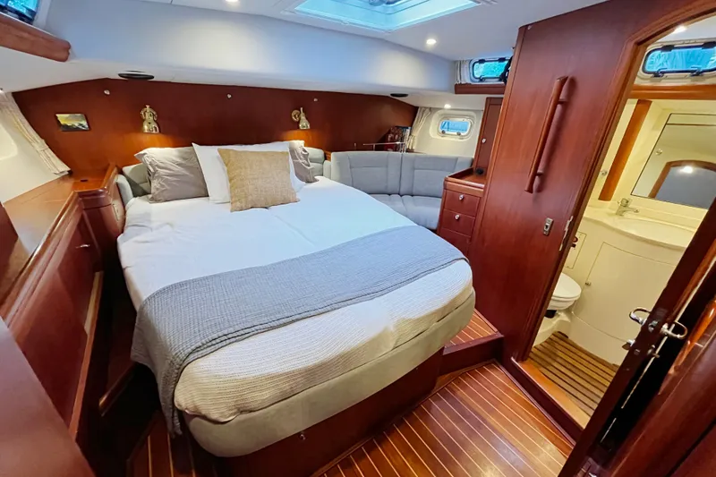 Slide: The Image of Luxurious cabin interior of a 1999 Oyster 53 Deck Saloon yacht with cozy bedding. - 27