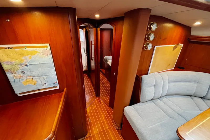 Slide: The Image of Luxurious interior of 1999 Oyster 53 Deck Saloon yacht with wood paneling and cozy seating. - 10