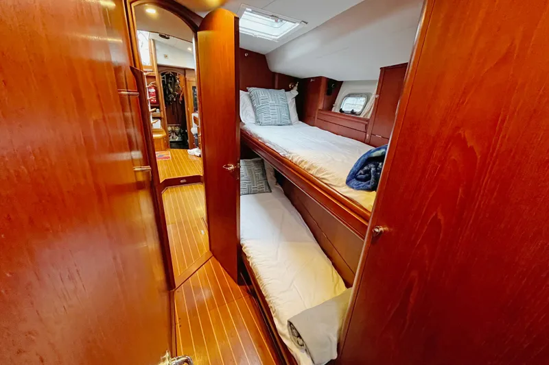 Slide: The Image of Interior of 1999 Oyster 53 Deck Saloon with wooden bunk beds and cozy decor. - 8