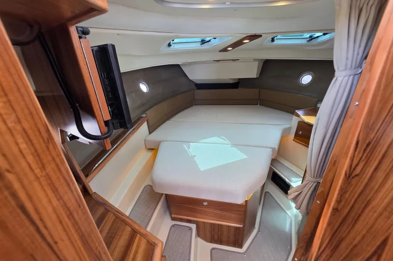 Slide: The Image of Interior cabin of 2026 Ranger Tugs R-29 CB with cozy seating and wood accents. - 12