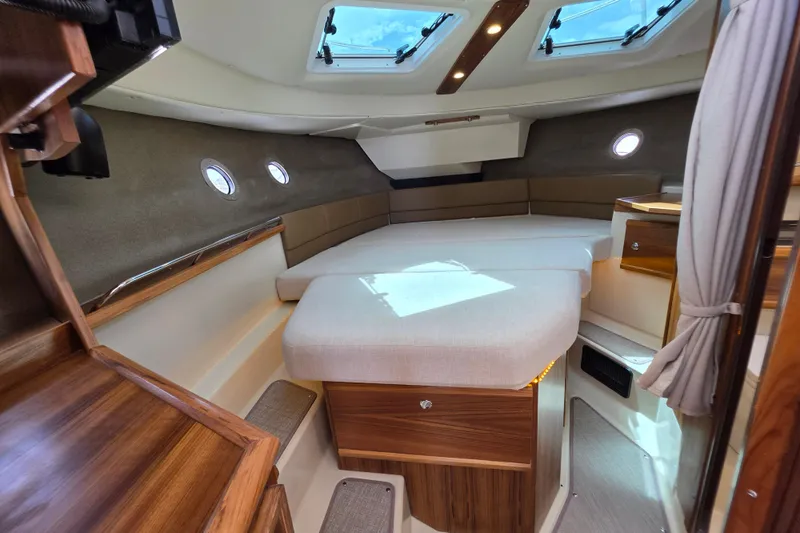 Slide: The Image of Luxurious interior of 2026 Ranger Tugs R-29 CB with elegant wood finishes and skylights. - 10
