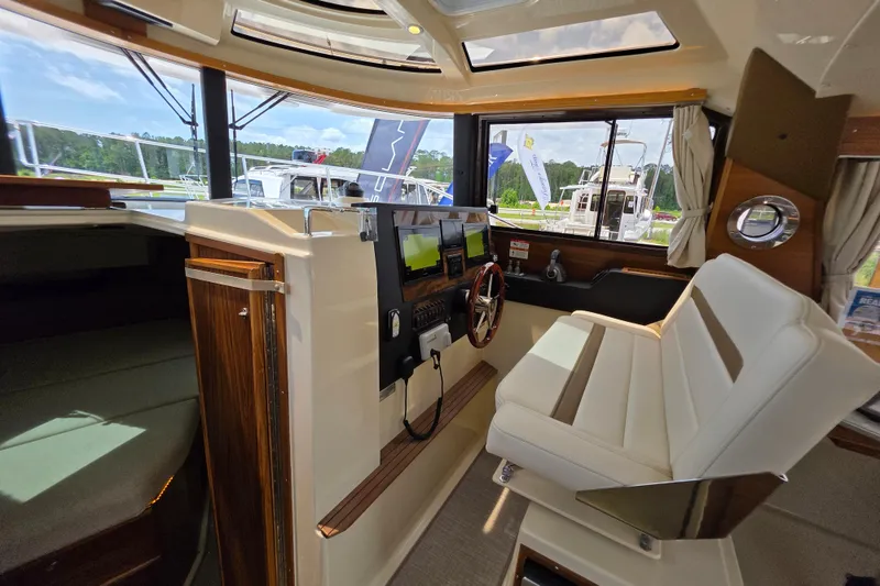 Slide: The Image of Interior of 2026 Ranger Tugs R-29 CB boat with modern helm and seating. - 6
