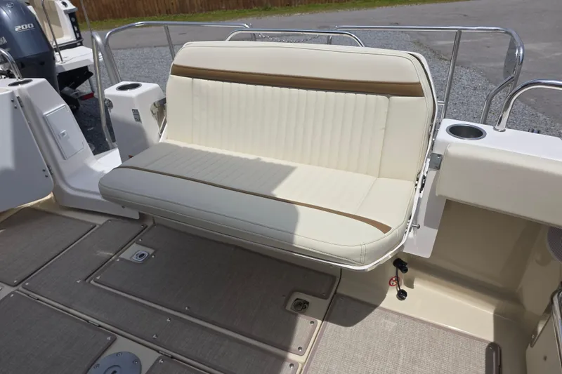 Slide: The Image of 2026 Ranger Tugs R-29 CB boat with beige cushioned seating and stainless steel railing. - 2