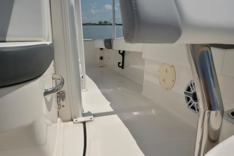 Slide: The Image of 2023 Robalo 246 Cayman boat interior with seating and speaker, overlooking water. - 38