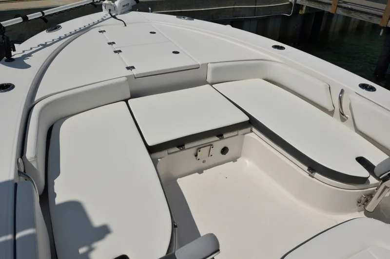 Slide: The Image of 2023 Robalo 246 Cayman boat interior with cushioned seating and storage compartments. - 33