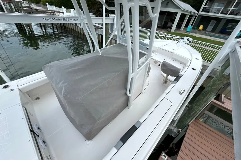 Slide: The Image of 2023 Robalo 246 Cayman boat docked, featuring covered seating and sleek design. - 47