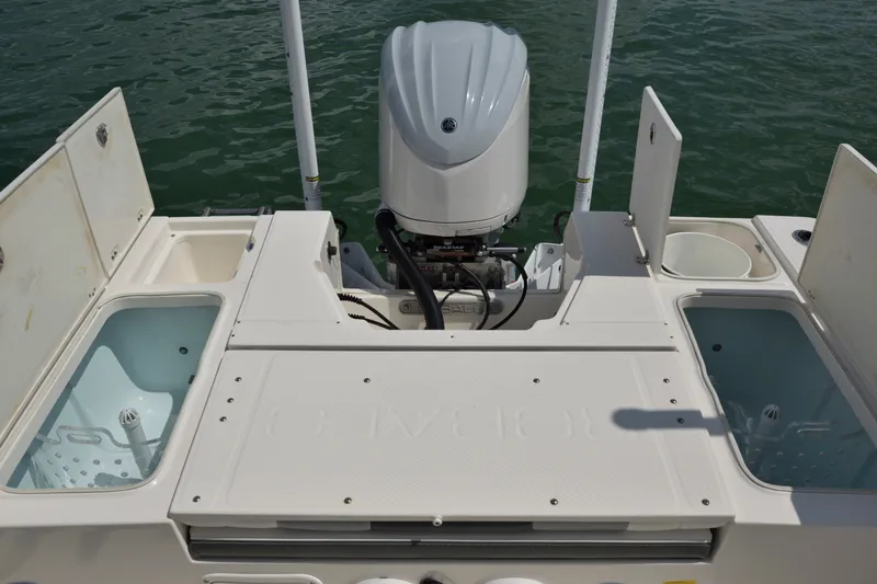 Slide: The Image of 2023 Robalo 246 Cayman boat stern with outboard motor and storage compartments. - 14