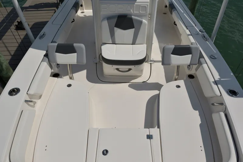 Slide: The Image of 2023 Robalo 246 Cayman boat interior with seating and storage compartments. - 26