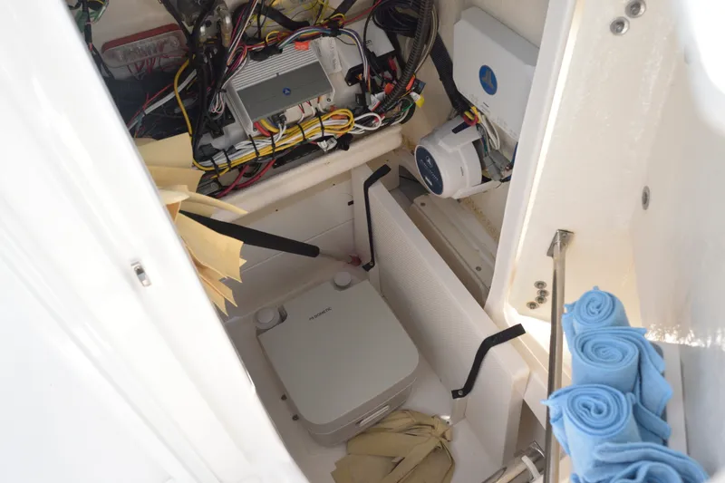 Slide: The Image of Interior view of 2023 Robalo 246 Cayman boat showing wiring and storage compartment. - 27