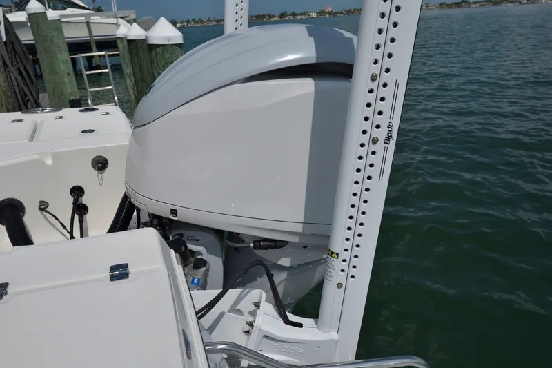 Slide: The Image of 2023 Robalo 246 Cayman boat engine and power pole by the water. - 8