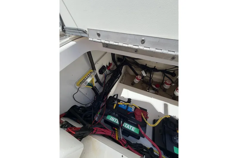 Slide: The Image of 2023 Robalo 246 Cayman boat battery compartment with wiring and components. - 17
