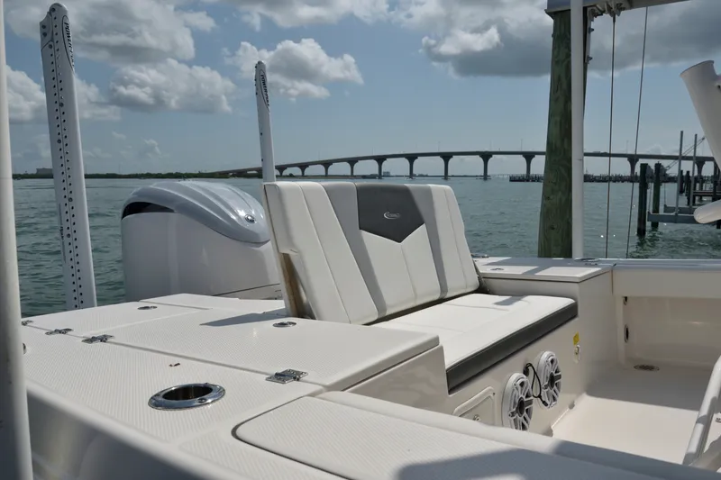 Slide: The Image of 2023 Robalo 246 Cayman boat interior with seating, on a sunny day by the water. - 10