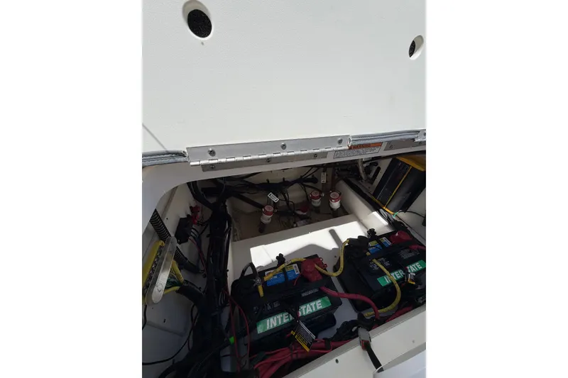 Slide: The Image of 2023 Robalo 246 Cayman boat battery compartment with Interstate batteries and wiring. - 18
