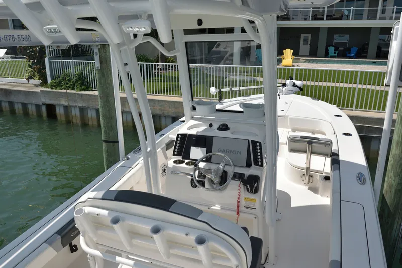 Slide: The Image of 2023 Robalo 246 Cayman boat interior with Garmin navigation system, docked by waterfront. - 40