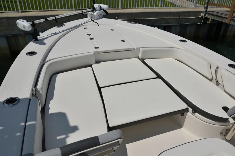 Slide: The Image of 2023 Robalo 246 Cayman boat interior with cushioned seating and fishing rod holders. - 31