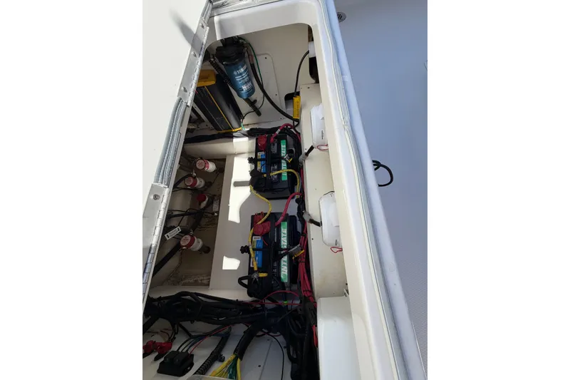 Slide: The Image of 2023 Robalo 246 Cayman boat battery compartment with wiring and components. - 19