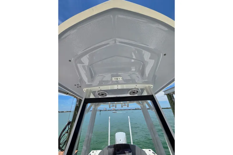 Slide: The Image of 2023 Robalo 246 Cayman boat interior view with speakers and clear sky. - 43