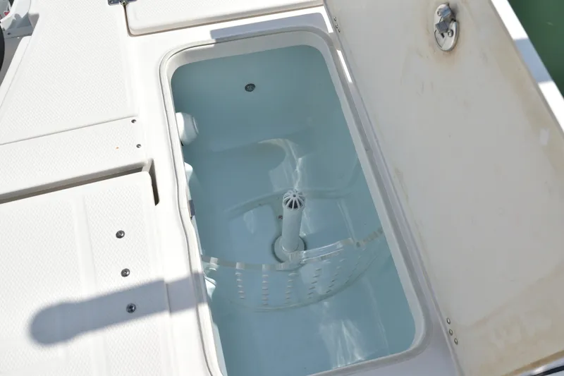 Slide: The Image of Livewell compartment on 2023 Robalo 246 Cayman boat, open lid view. - 13