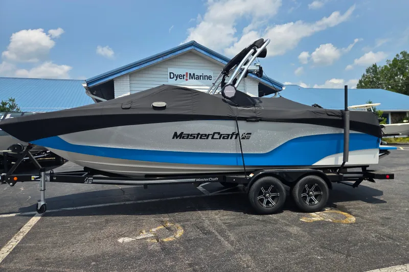 The Image of 2023 MasterCraft XT24 boat on trailer at Dyer Marine dealership. - 0