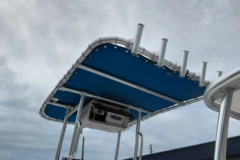 Slide: The Image of Boat T-top with rod holders on a 2000 Eagle 21, under cloudy sky. - 17