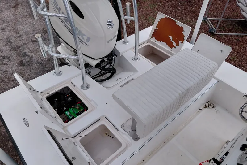 Slide: The Image of Boat interior with Suzuki engine, storage compartments, and seating. Eagle 21 model, year 2000. - 14