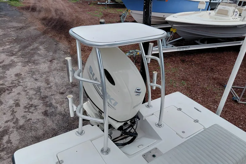 Slide: The Image of Boat with Suzuki outboard motor, Eagle 21 model, year 2000, parked on gravel. - 24