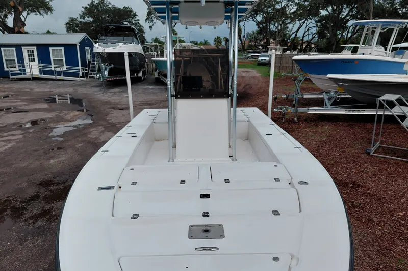 Slide: The Image of Boat docked on land, Eagle 21 model, year 2000, with surrounding boats and trees. - 19