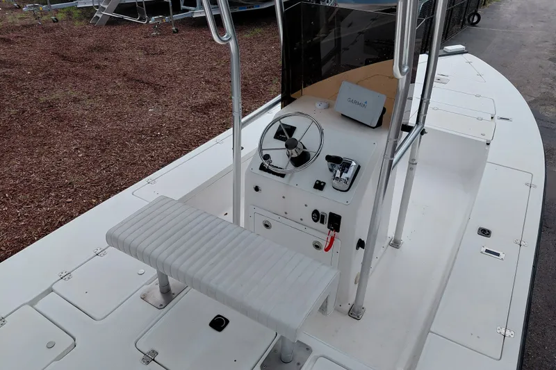 Slide: The Image of Center console of a 2000 Eagle 21 boat with steering wheel and Garmin device. - 25