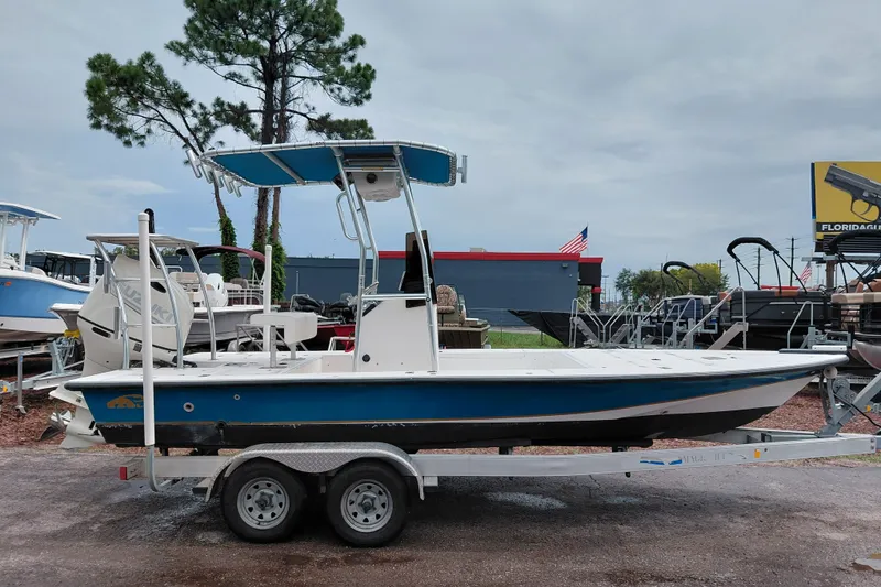 The Image of 2000 Eagle 21 boat on trailer, parked outdoors with overcast sky. - 1