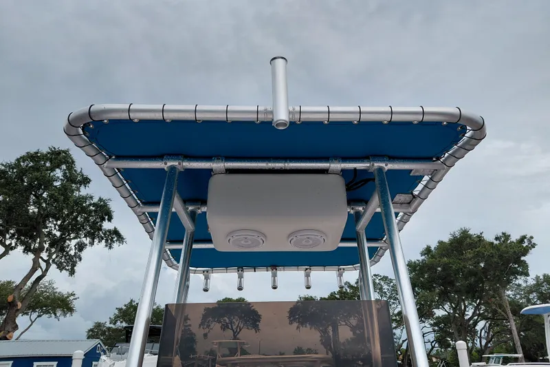 Slide: The Image of Aluminum-framed blue canopy on a 2000 Eagle 21 boat, with cloudy sky background. - 16