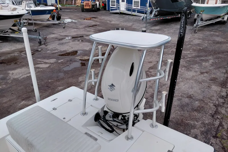 Slide: The Image of Boat motor on Eagle 21, 2000 model, in a marina with other boats. - 23