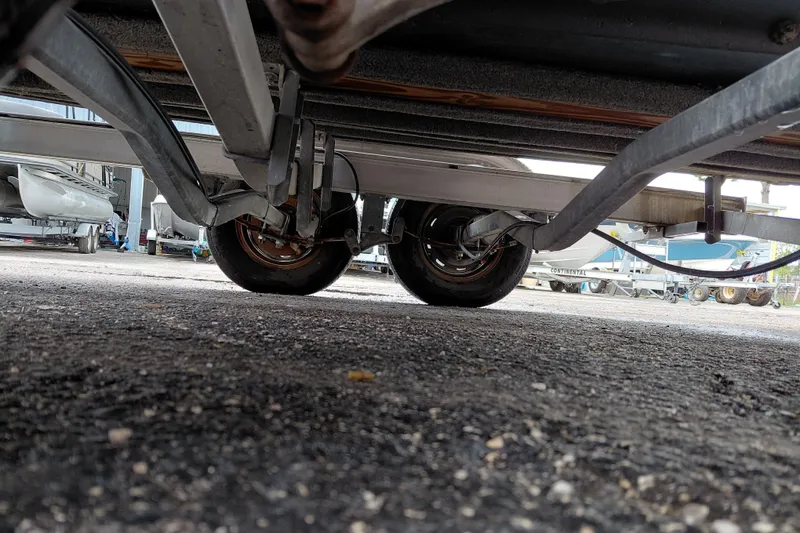 Slide: The Image of Underneath view of a 2000 Eagle 21 trailer, showcasing wheels and suspension. - 18
