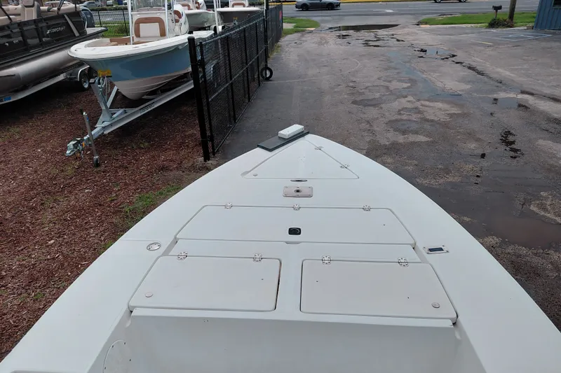 Slide: The Image of Bow view of a 2000 Eagle 21 boat parked near other boats. - 27