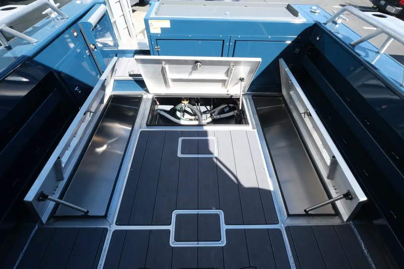 Slide: The Image of 2026 Hewescraft 250 Pacific Explorer boat deck with open storage compartments. - 21