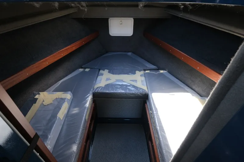 Slide: The Image of Interior cabin of 2026 Hewescraft 250 Pacific Explorer boat, featuring cushioned seating. - 16